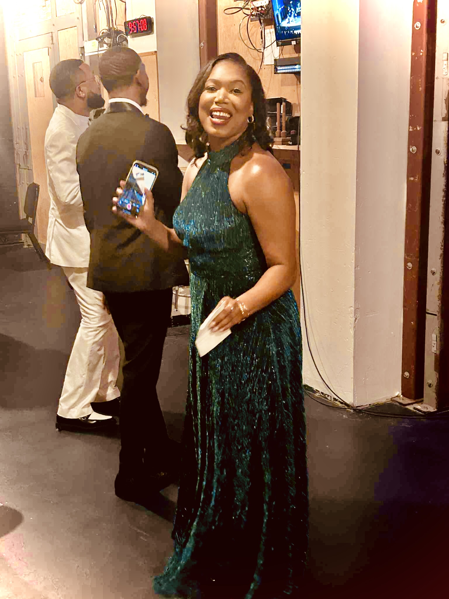 Nikki B backstage in an emerald gown before a major event